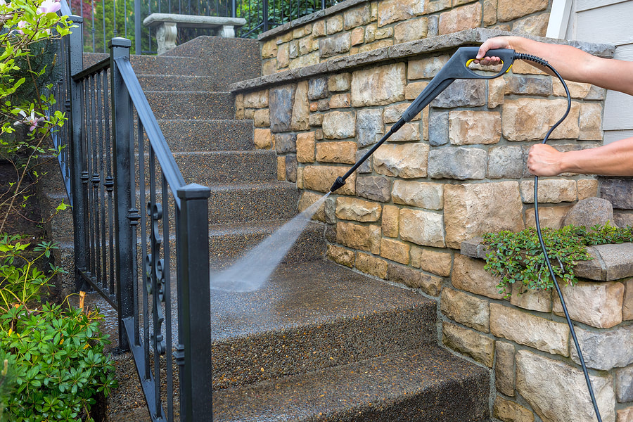 a man cleaning the bconcrete stair